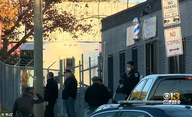 Off-duty Baltimore cop getting a hair cut shoots dead gunman who opened fire in barbershop, killing the owner